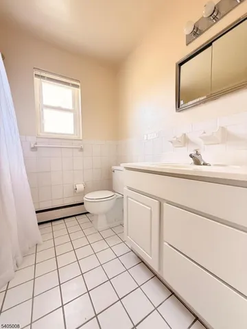 a bathroom with a sink toilet and mirror