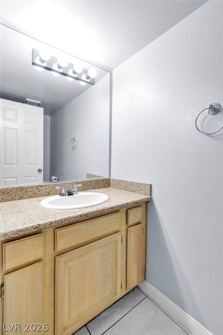 6250 West Flamingo Road, Unit 98 Las Vegas, NV 89103 - Photo 32 of 40 Bathroom featuring baseboards, tile patterned floors, and vanity