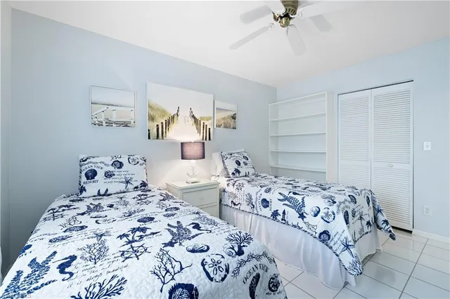 a bedroom with two beds and a chandelier