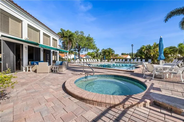 a swimming pool with outdoor seating and yard