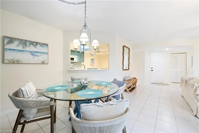 a dining room with furniture and a chandelier