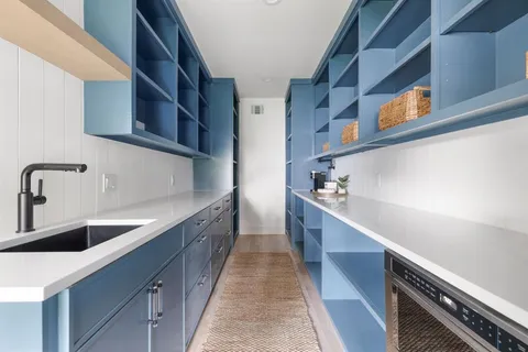 a kitchen with stainless steel appliances a sink and cabinets
