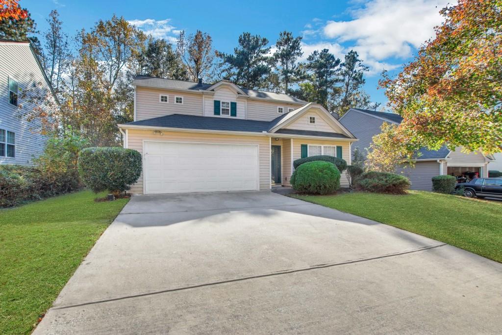 a front view of a house with a yard and garage