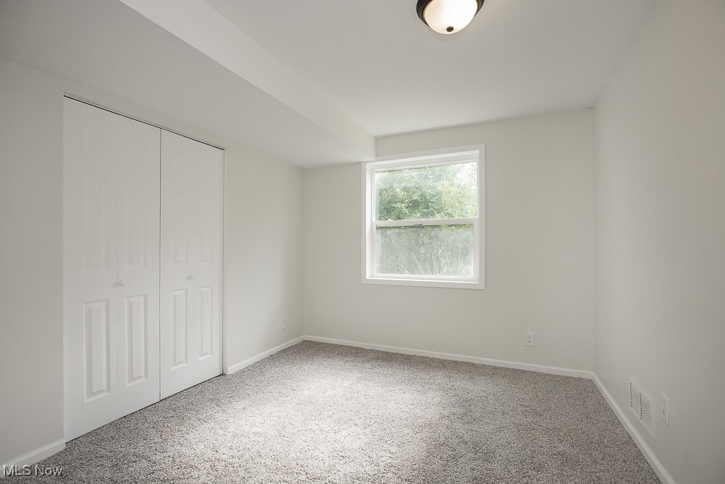 4670 Green Road Cleveland, OH 44128 - Photo 16 of 38 Unfurnished bedroom with a closet and carpet flooring