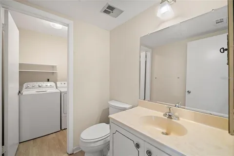 a bathroom with a sink toilet and mirror