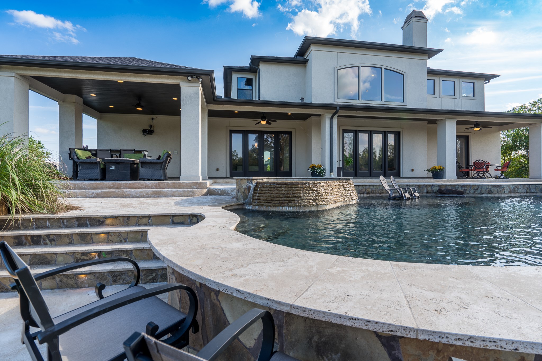 12748 Roy Road Pearland, TX 77581 - Photo 12 of 50 Travertine ledge morphs into a serving space at the raised bar conveniently located next to the summer kitchen.