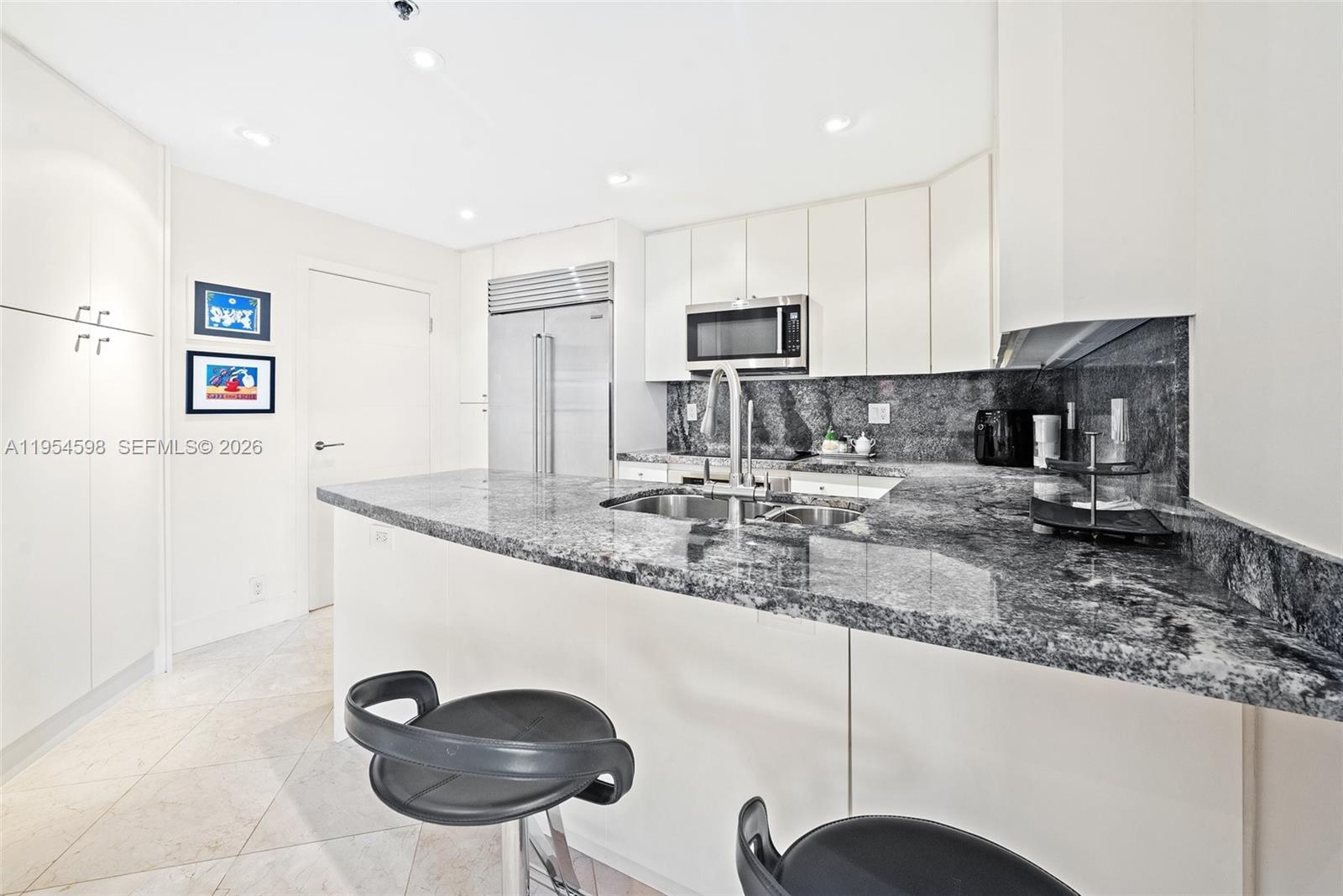 Key Biscayne Key Biscayne, FL 33149 - Photo 12 of 25 a kitchen with stainless steel appliances granite countertop a sink a stove and a refrigerator