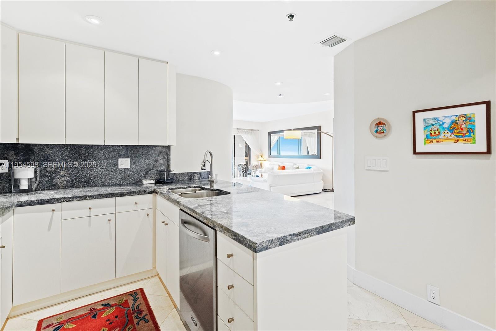 Key Biscayne Key Biscayne, FL 33149 - Photo 14 of 25 a kitchen with stainless steel appliances granite countertop a sink stove and cabinets