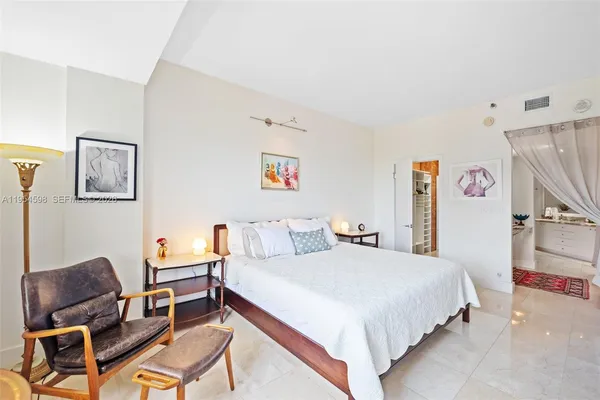 a bedroom with a bed and chair