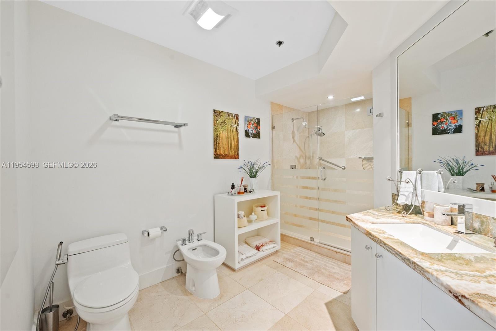 Key Biscayne Key Biscayne, FL 33149 - Photo 19 of 25 a bathroom with a granite countertop sink mirror vanity and toilet