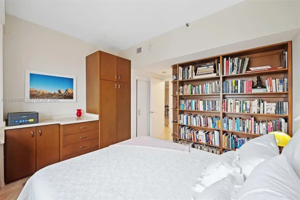 a bed room with a bed and a book shelf