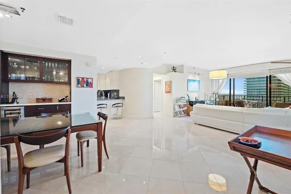 a living room with furniture and a kitchen area