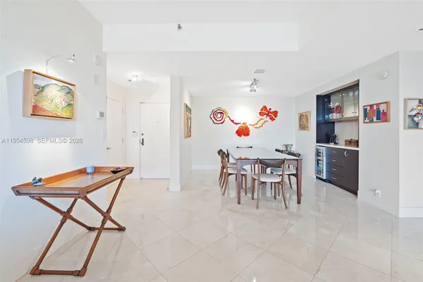 a dining room with furniture and a kitchen view