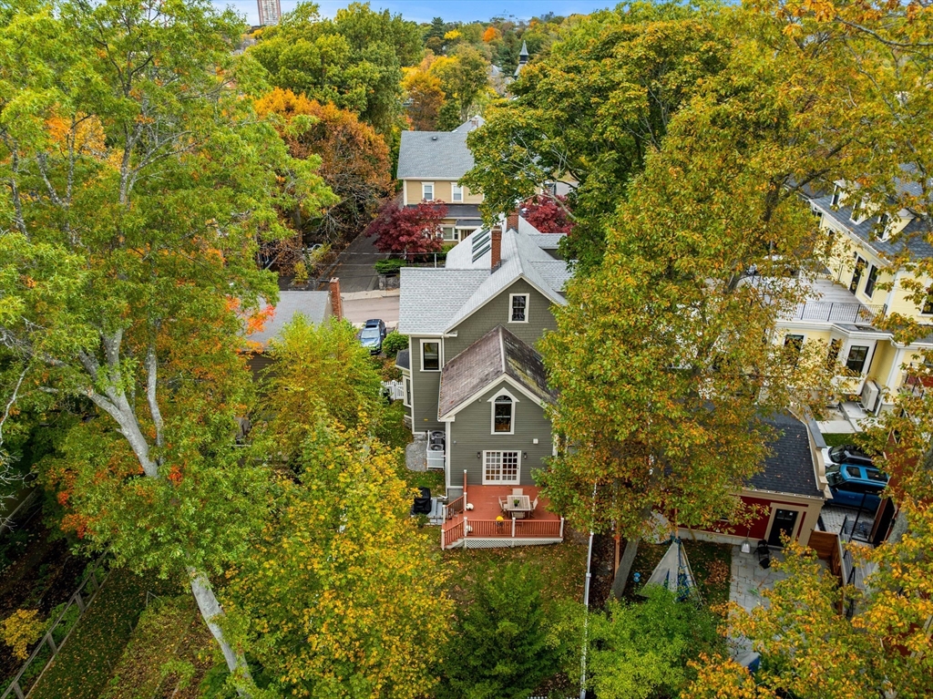 15 Harris Avenue Boston, MA 02130 - Photo 26 of 27 a aerial view of a house with a yard fire pit and trees