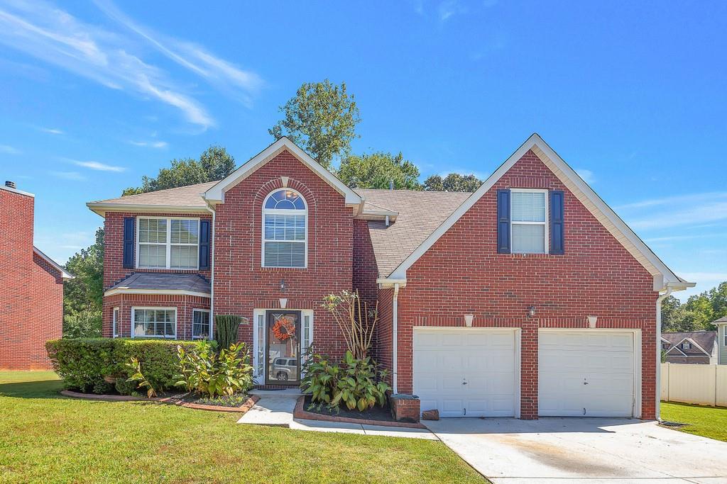 6340 Selborn Drive Southwest Atlanta, GA 30331 - Photo 1 of 1 a front view of a house with a yard and garage