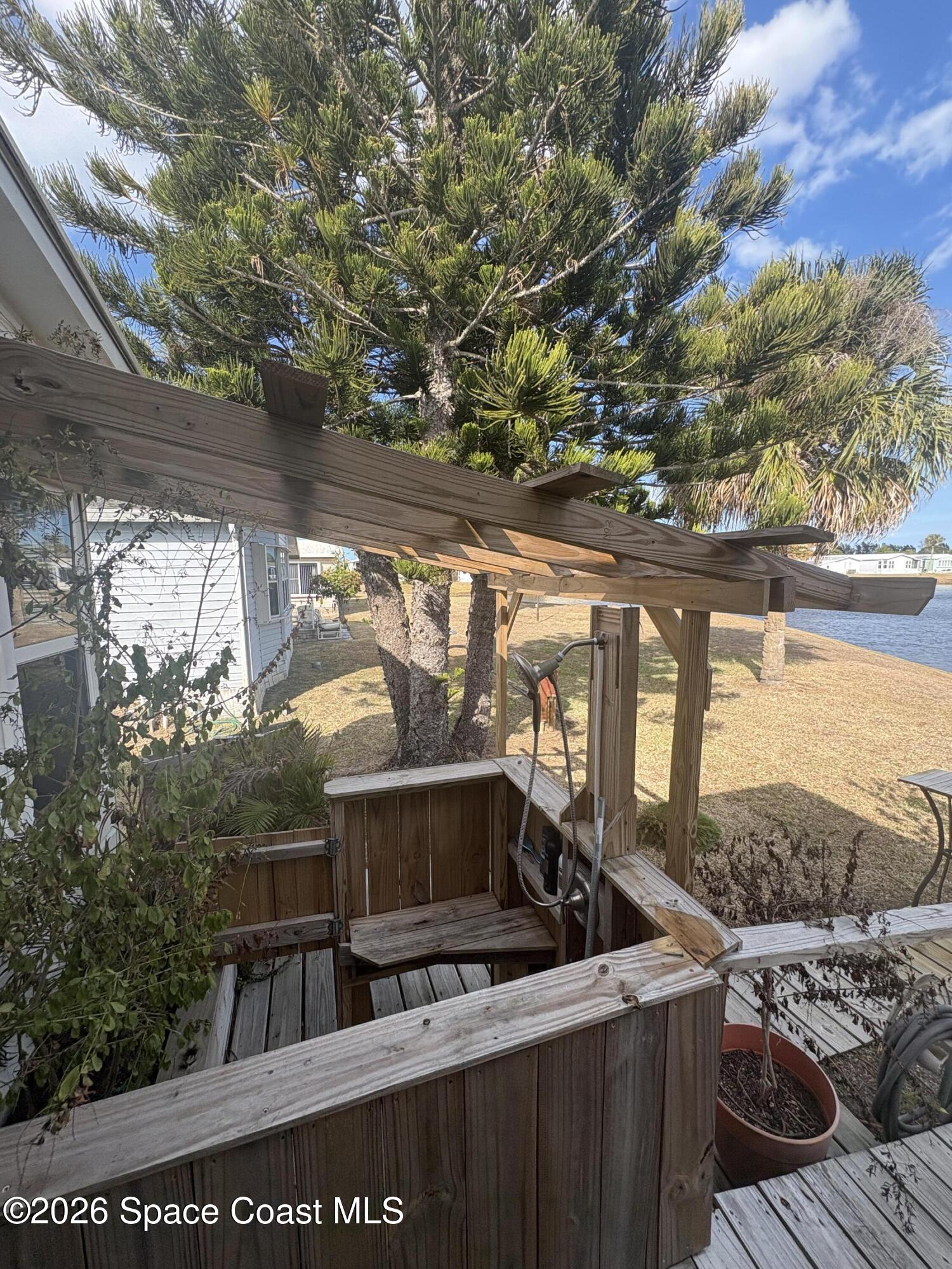 7625 Longhorn Avenue, Unit P3 Micco, FL 32976 - Photo 11 of 40 a view of a balcony with furniture and a garden