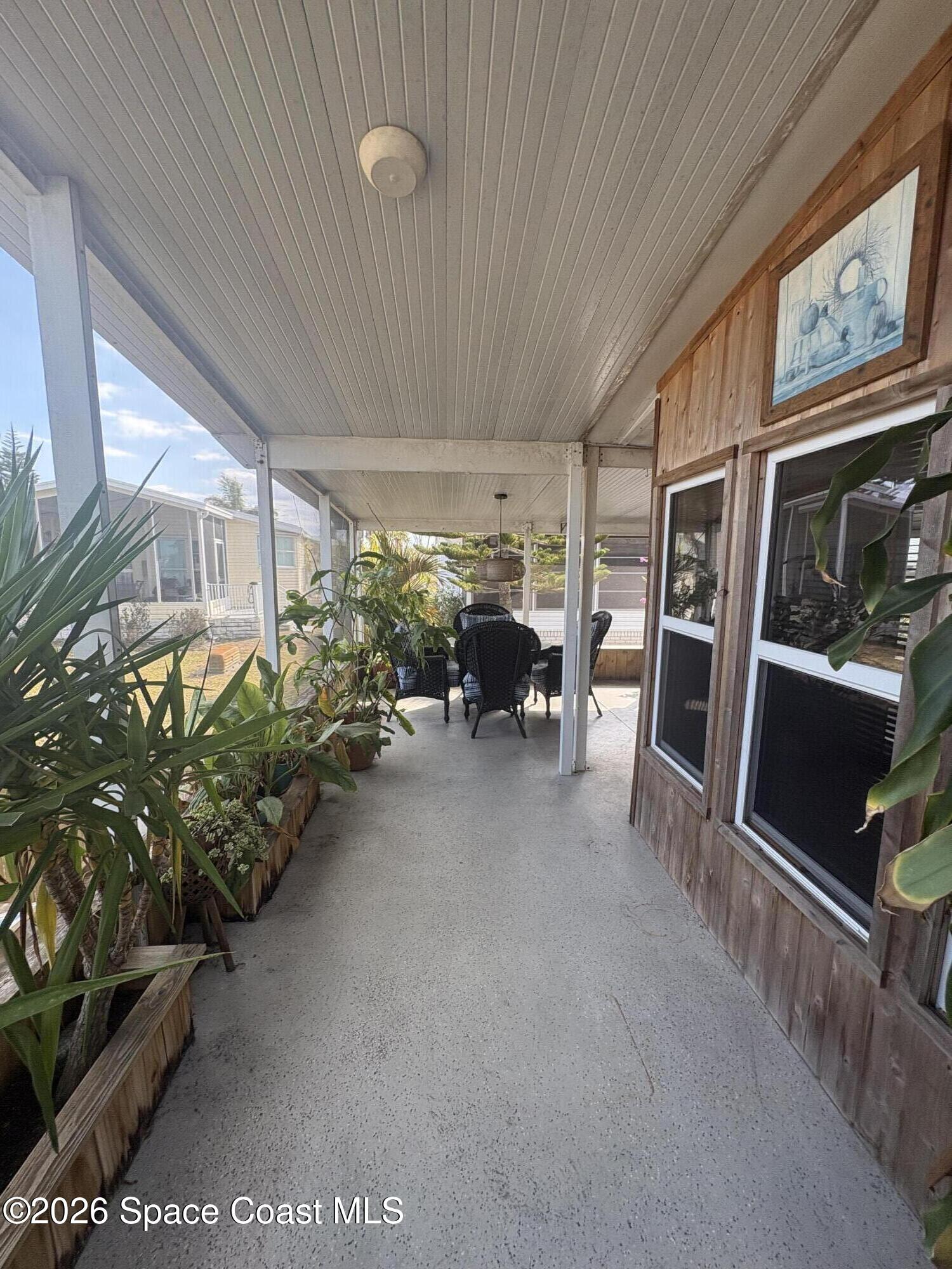 7625 Longhorn Avenue, Unit P3 Micco, FL 32976 - Photo 13 of 40 a view of a patio with furniture and a garage