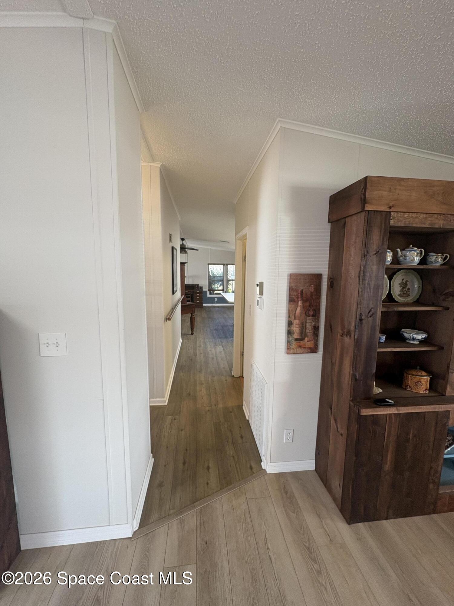 7625 Longhorn Avenue, Unit P3 Micco, FL 32976 - Photo 18 of 40 a view of a hallway with wooden floor and furniture