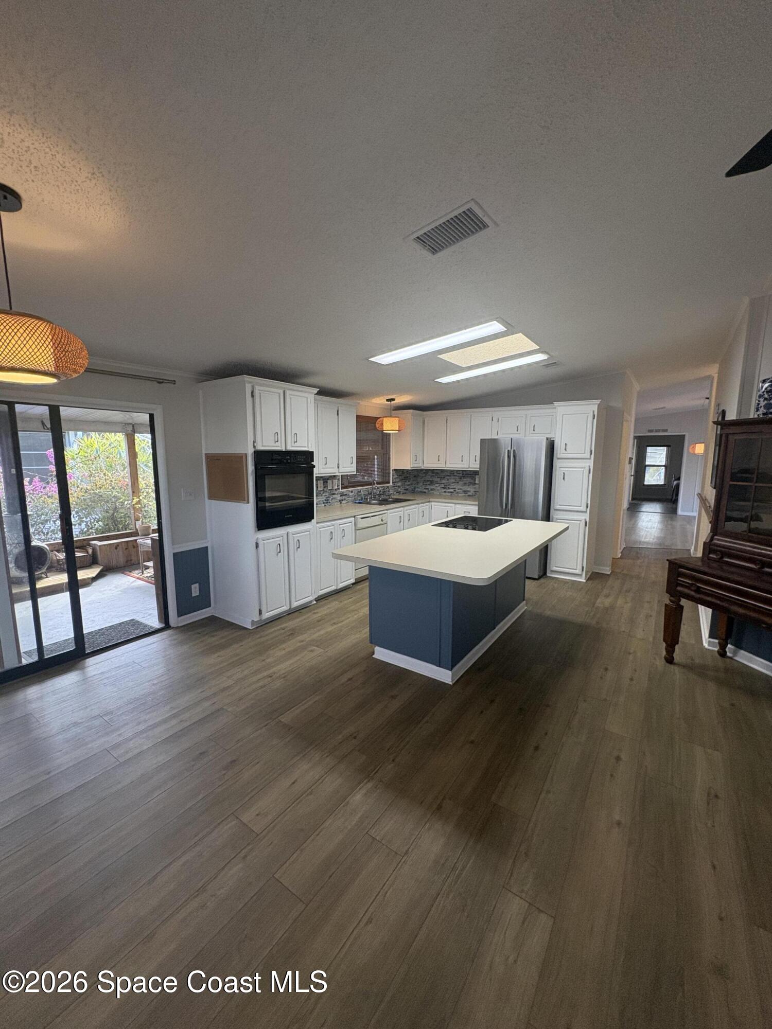 7625 Longhorn Avenue, Unit P3 Micco, FL 32976 - Photo 19 of 40 a large kitchen with a table and chairs in it