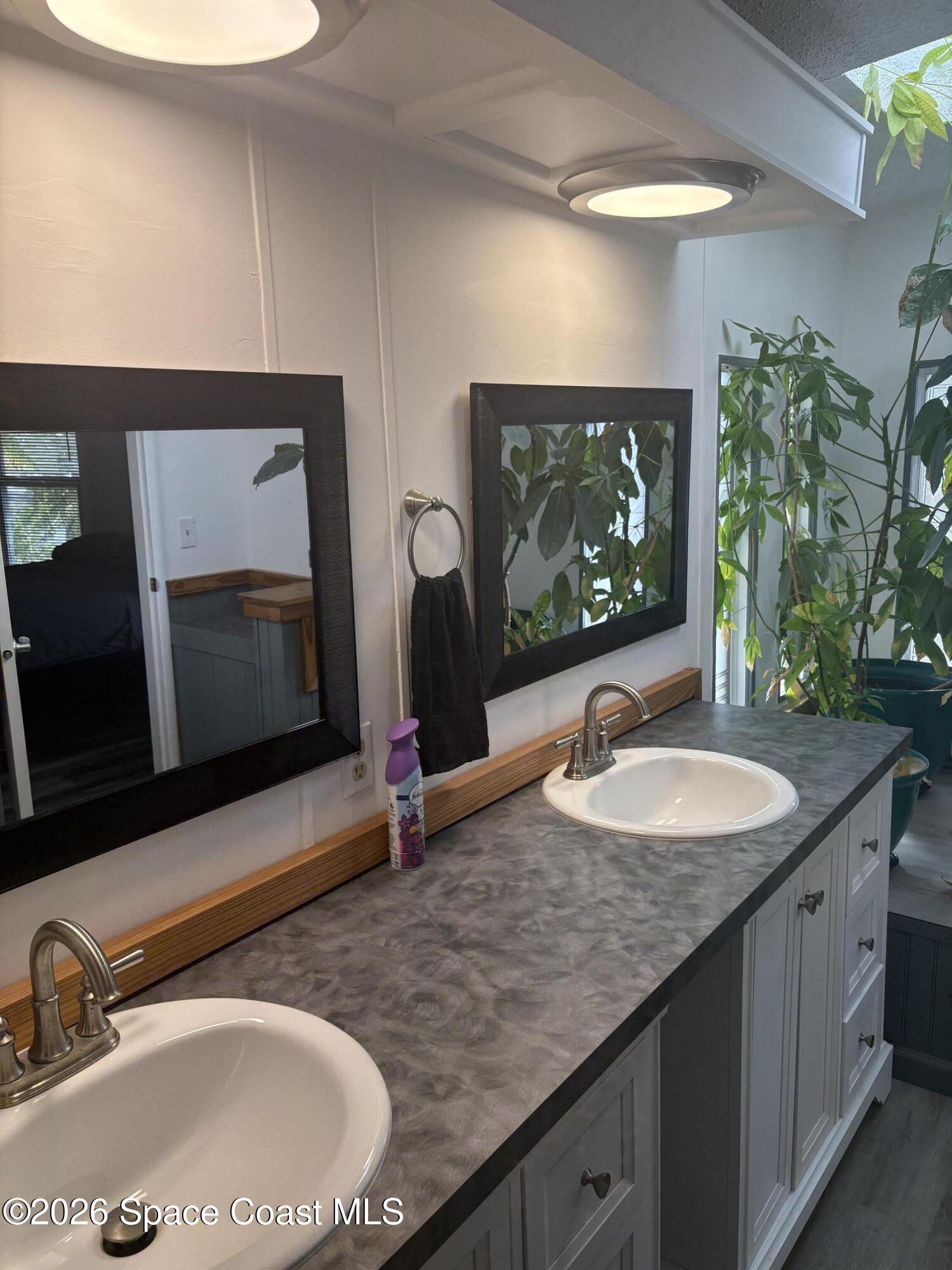 7625 Longhorn Avenue, Unit P3 Micco, FL 32976 - Photo 28 of 40 a bathroom with a double vanity sink and a mirror