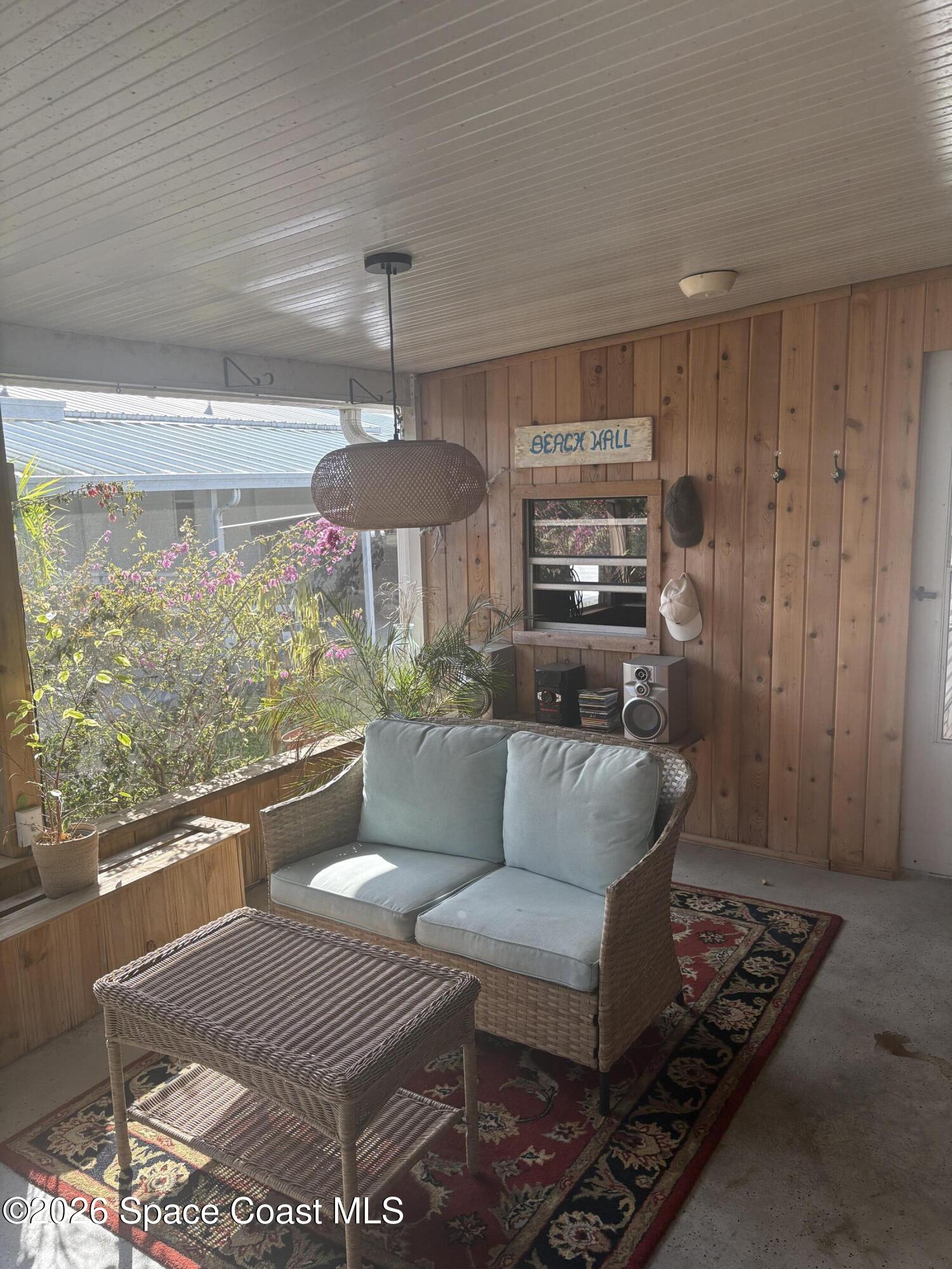 7625 Longhorn Avenue, Unit P3 Micco, FL 32976 - Photo 3 of 40 a living room with furniture and a large window