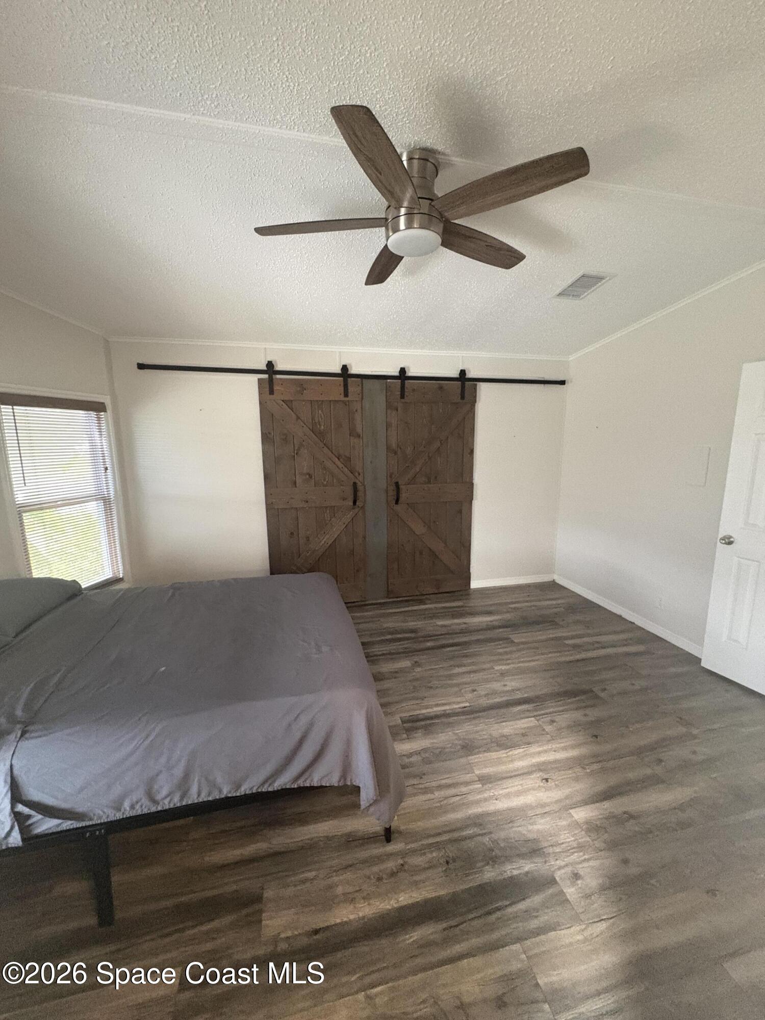 7625 Longhorn Avenue, Unit P3 Micco, FL 32976 - Photo 31 of 40 a bedroom with a bed and a ceiling fan