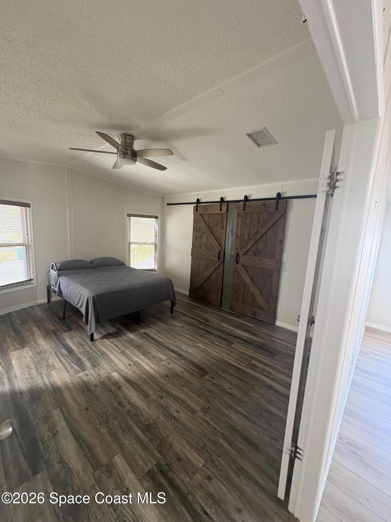 7625 Longhorn Avenue, Unit P3 Micco, FL 32976 - Photo 32 of 40 a living room with two couch and a window