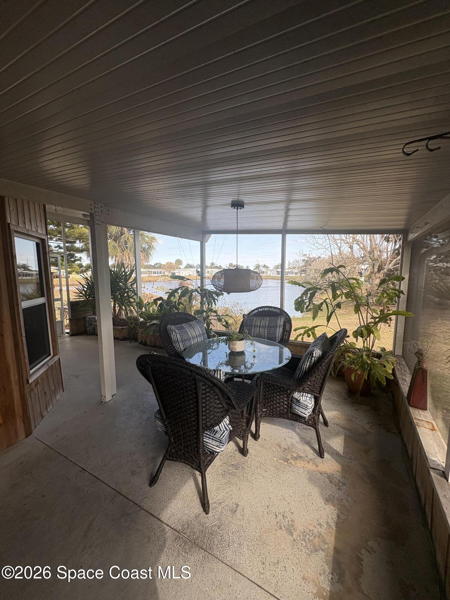 7625 Longhorn Avenue, Unit P3 Micco, FL 32976 - Photo 40 of 40 a living room with furniture and a floor to ceiling window