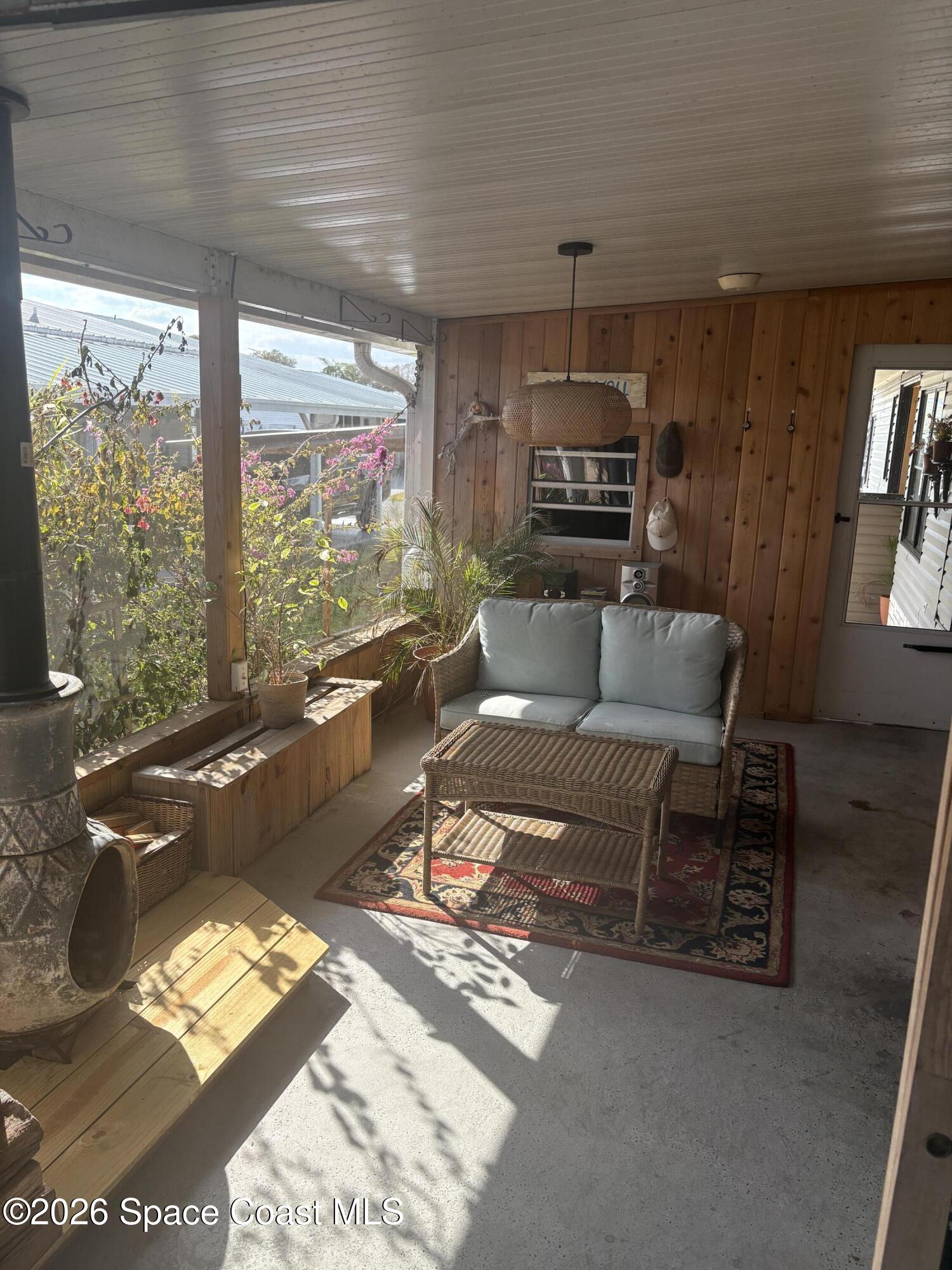 7625 Longhorn Avenue, Unit P3 Micco, FL 32976 - Photo 4 of 40 a living room with furniture and a floor to ceiling window