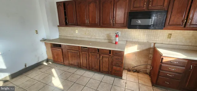 a kitchen with a sink a stove and a refrigerator