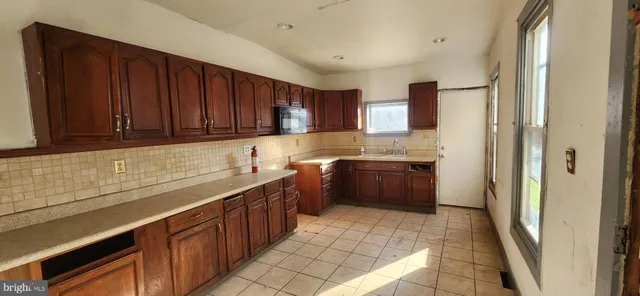 a kitchen with stainless steel appliances a refrigerator and a sink