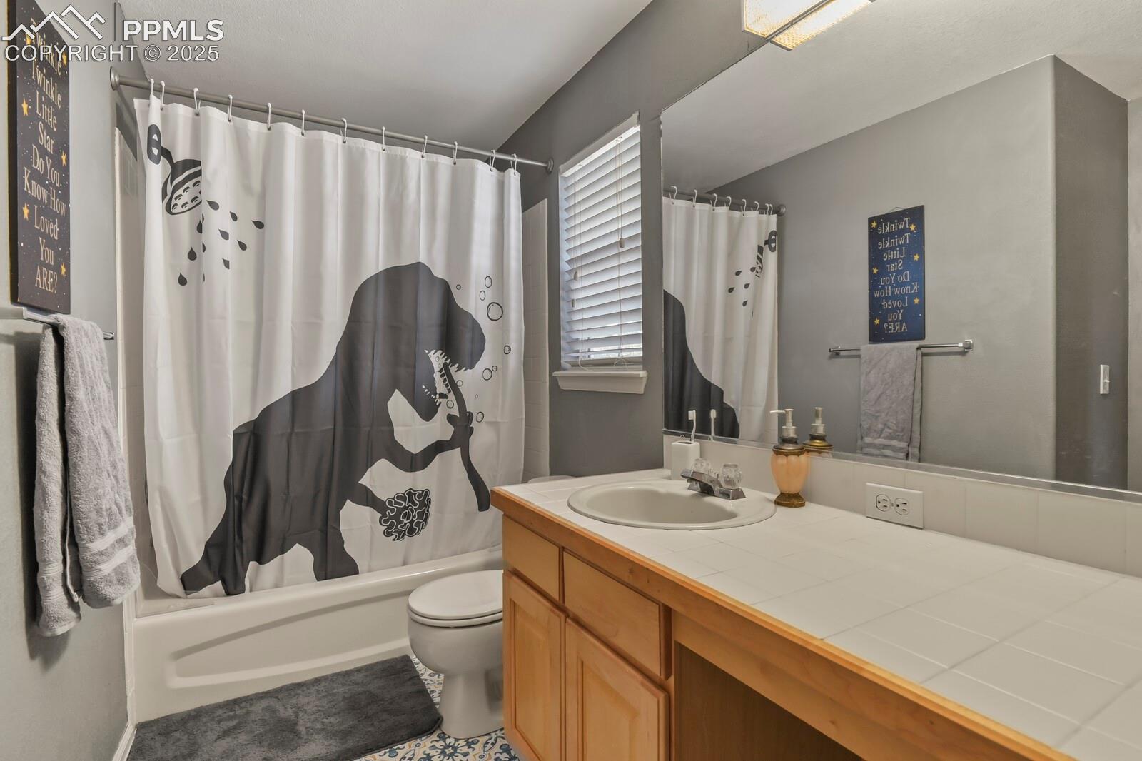 7660 Bullet Road Peyton, CO 80831 - Photo 26 of 50 Full bathroom featuring shower / bath combo with shower curtain and vanity