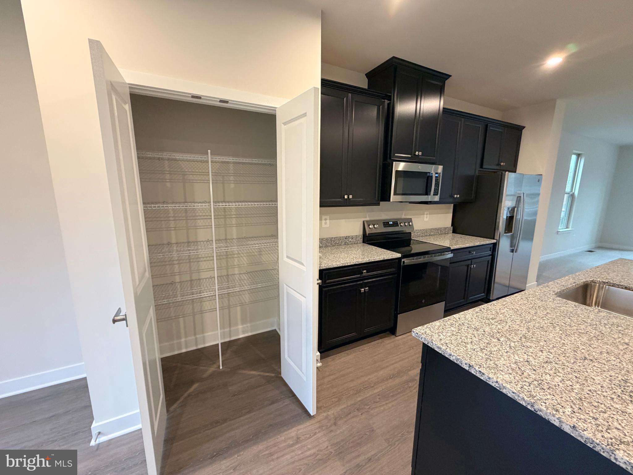 9331 Klamath Court Frederick, MD 21701 - Photo 11 of 28 a kitchen with a refrigerator and a sink