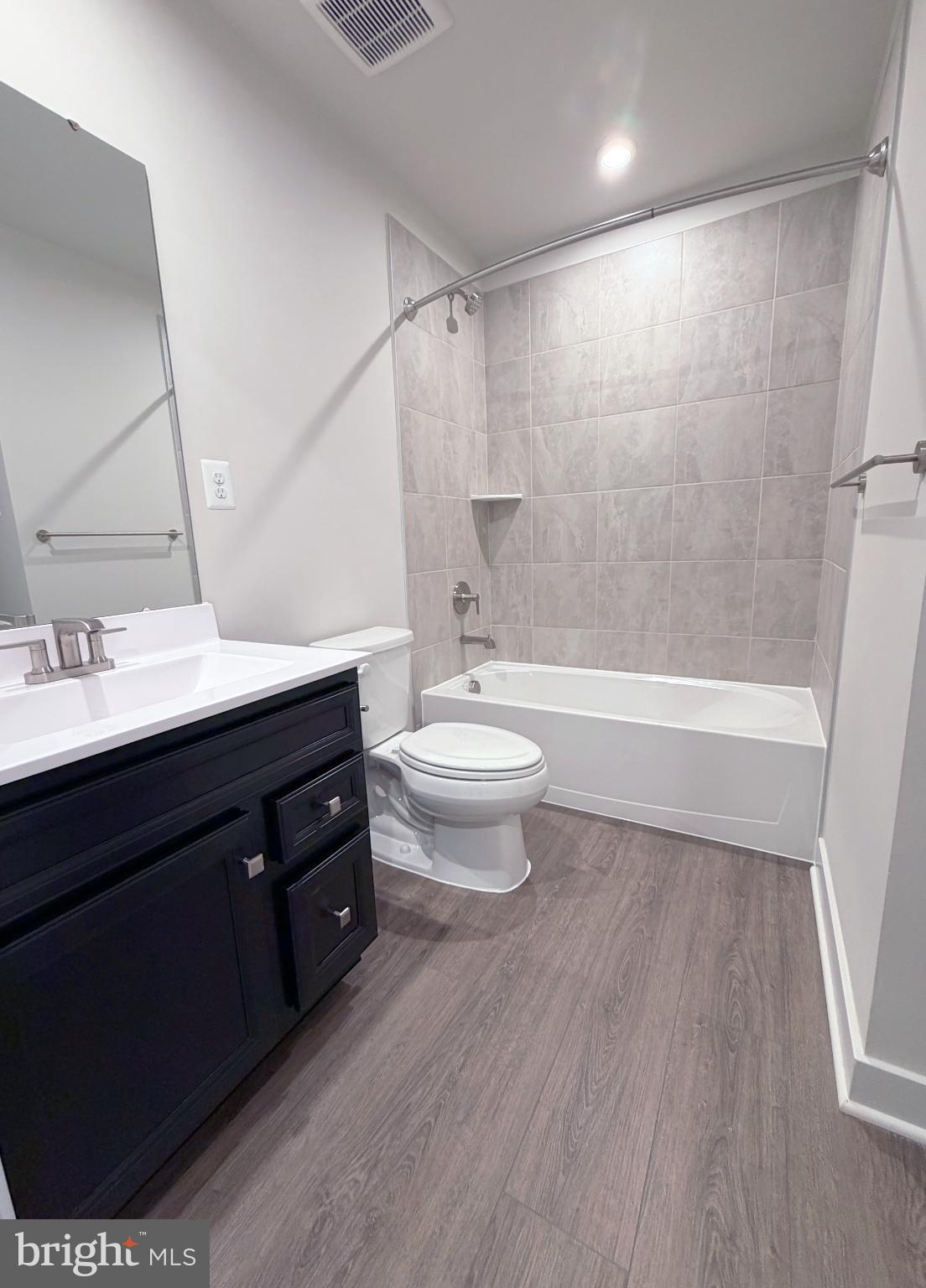 9331 Klamath Court Frederick, MD 21701 - Photo 8 of 28 a bathroom with a sink a toilet a mirror and a bathtub