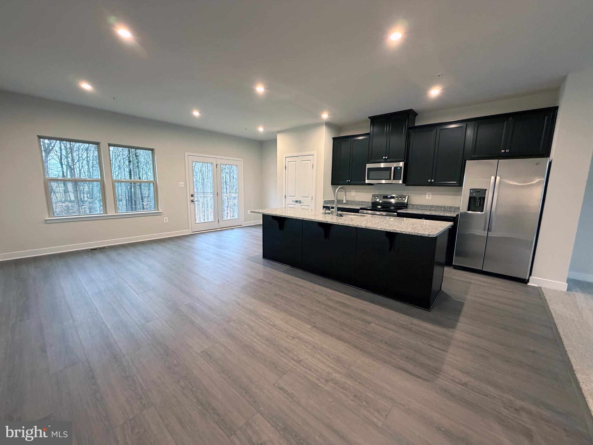 9331 Klamath Court Frederick, MD 21701 - Photo 10 of 28 a view of kitchen with stainless steel appliances granite countertop a sink and wooden floor