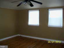 1649 Naturo Road Baltimore, MD 21286 - Photo 2 of 4 a view of a small space with wooden floor and a window