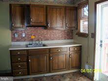 1649 Naturo Road Baltimore, MD 21286 - Photo 3 of 4 a kitchen with granite countertop a sink and a stove