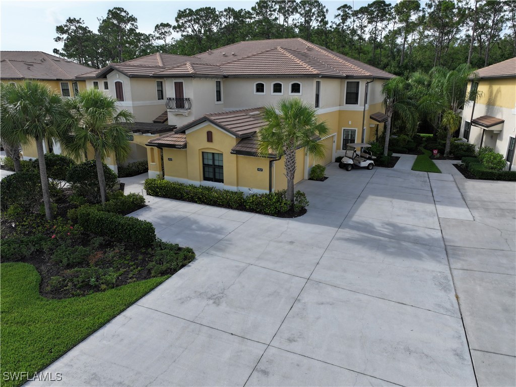 10459 Casella Way, Unit 102 Fort Myers, FL 33913 - Photo 1 of 29 a front view of a house with garden