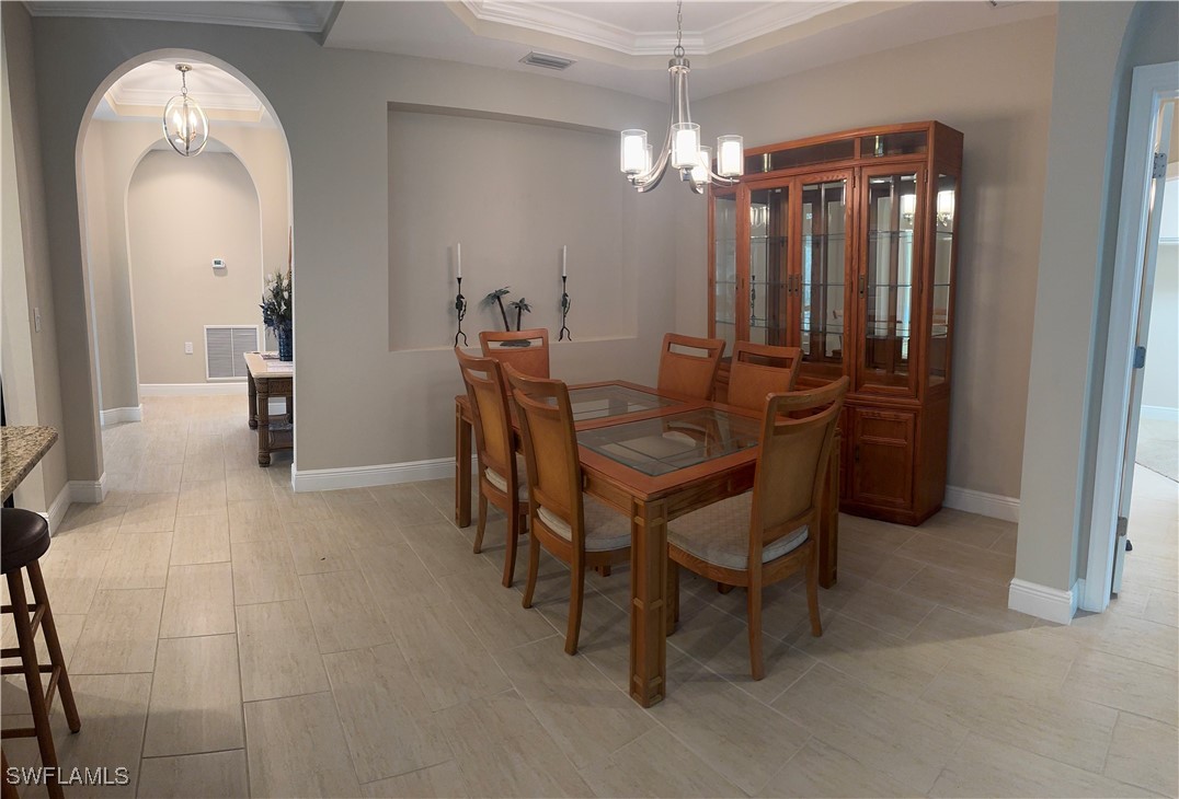 10459 Casella Way, Unit 102 Fort Myers, FL 33913 - Photo 11 of 29 a dining room with furniture and chandelier kitchen view