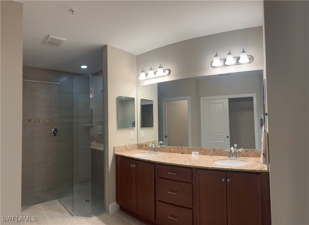 10459 Casella Way, Unit 102 Fort Myers, FL 33913 - Photo 17 of 29 a bathroom with double vanity sink and a mirror
