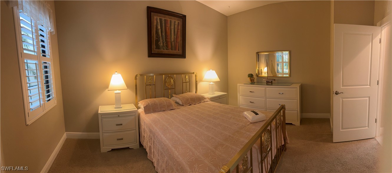 10459 Casella Way, Unit 102 Fort Myers, FL 33913 - Photo 19 of 29 a bedroom with a bed and a cabinets