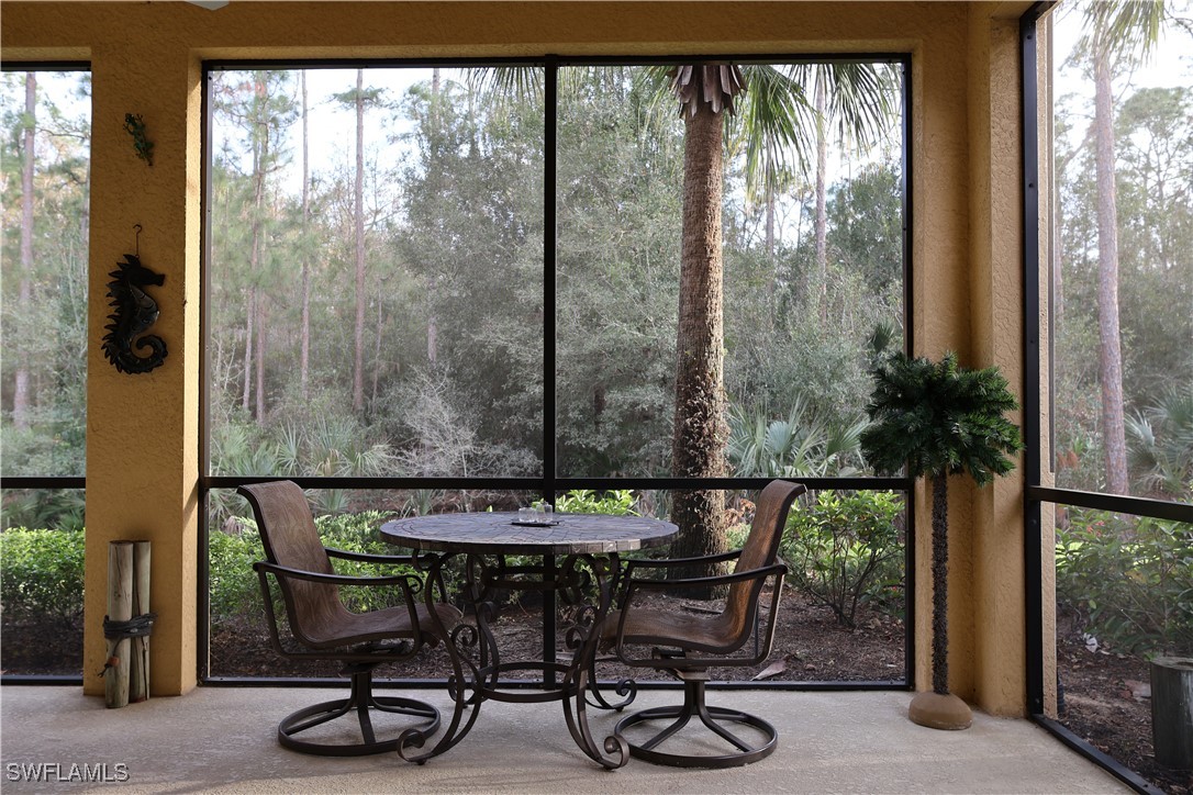 10459 Casella Way, Unit 102 Fort Myers, FL 33913 - Photo 22 of 29 a patio with table and chairs and potted plants