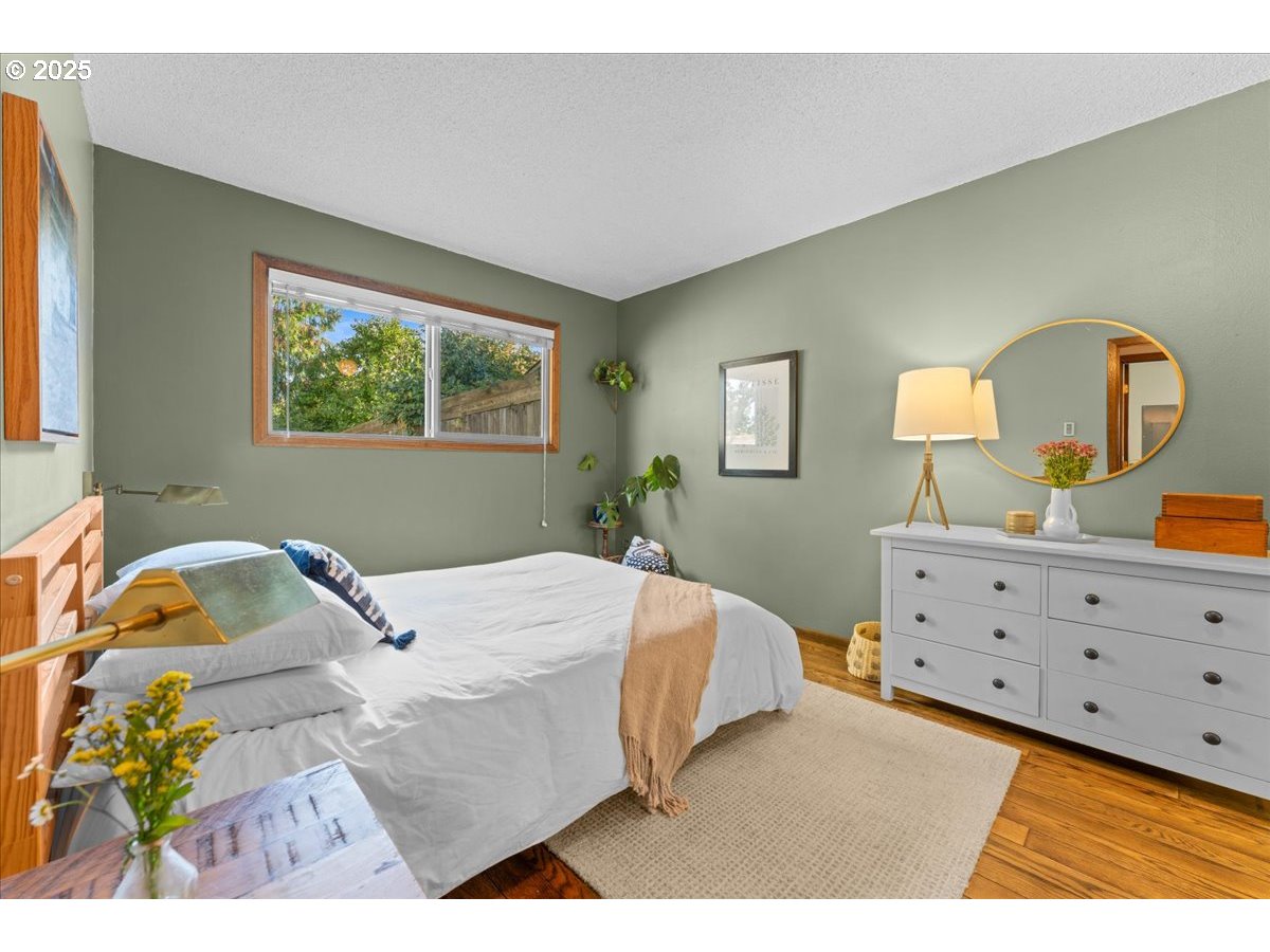 3837 North Juneau Street Portland, OR 97203 - Photo 12 of 32 a bedroom with a bed and a dresser