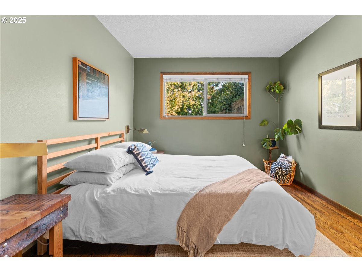 3837 North Juneau Street Portland, OR 97203 - Photo 13 of 32 a bedroom with a bed and a painting on the wall