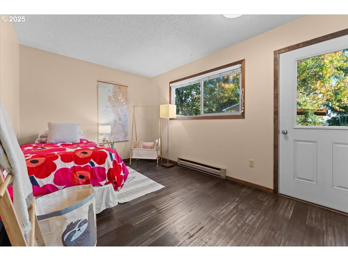 3837 North Juneau Street Portland, OR 97203 - Photo 17 of 32 a bedroom with a bed and a painting on the wall