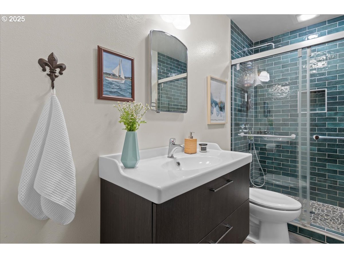 3837 North Juneau Street Portland, OR 97203 - Photo 21 of 32 a bathroom with a sink toilet and shower