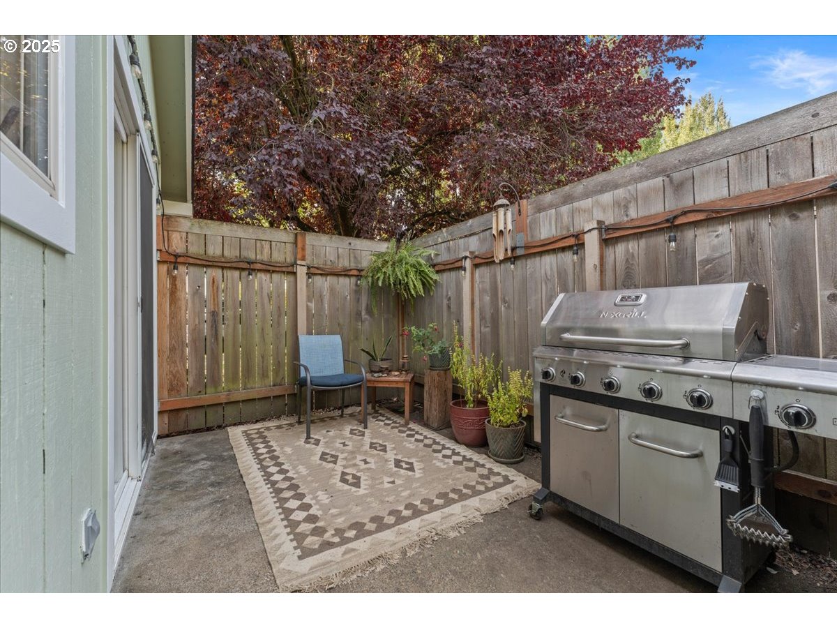 3837 North Juneau Street Portland, OR 97203 - Photo 23 of 32 a backyard of a house with barbeque oven and outdoor seating