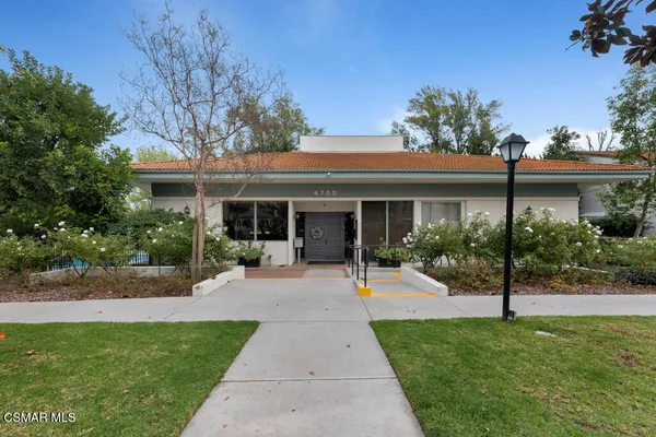 a front view of a house with a garden and porch