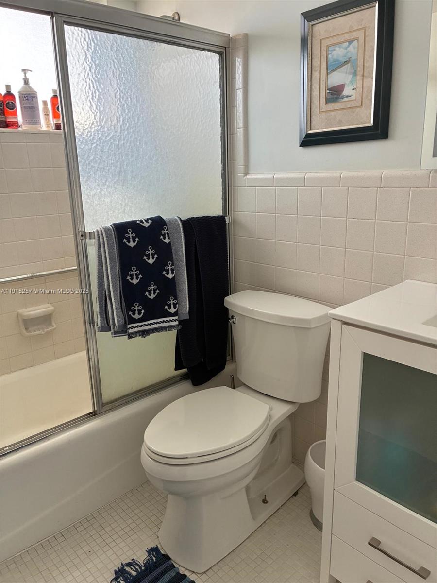 2050 Northeast 39th Street, Unit 311 Lighthouse Point, FL 33064 - Photo 11 of 17 a white toilet sitting next to a bathroom sink