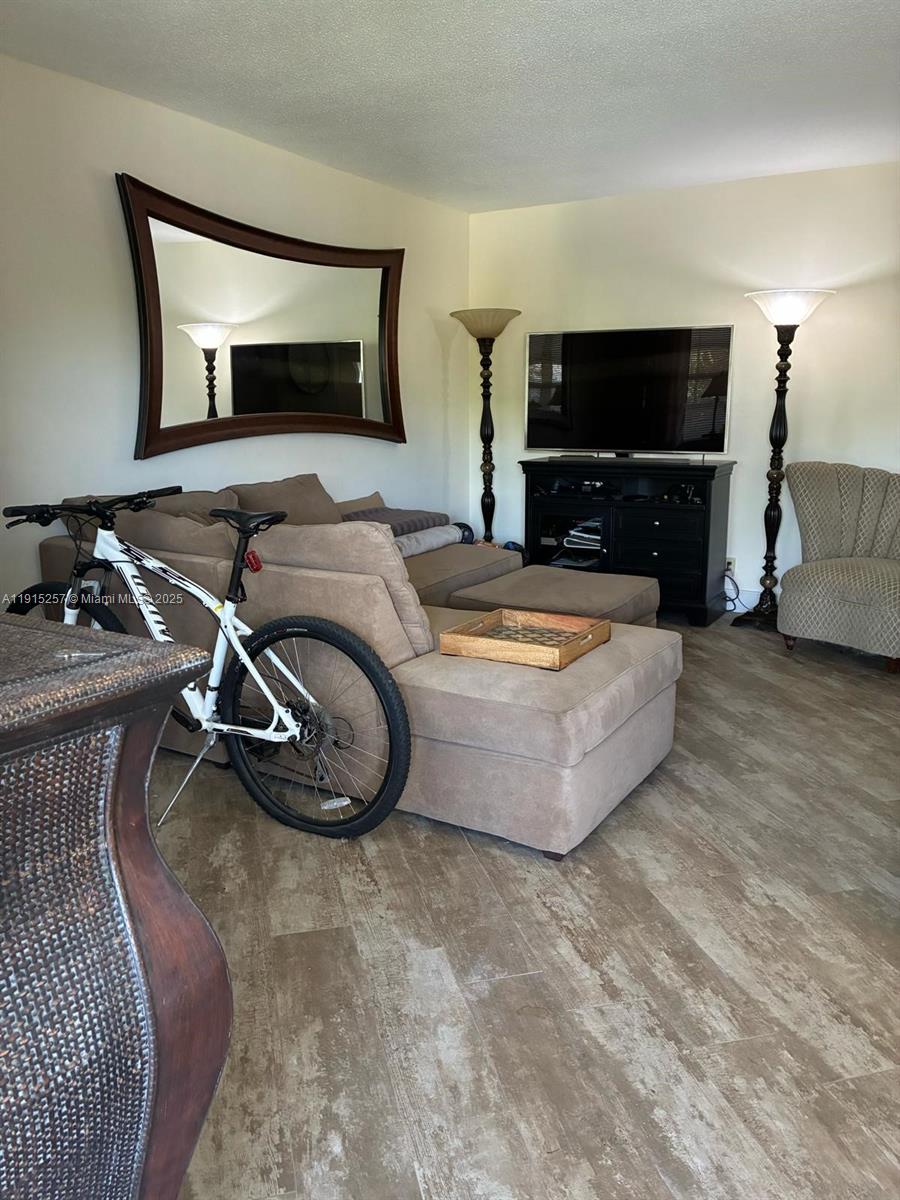2050 Northeast 39th Street, Unit 311 Lighthouse Point, FL 33064 - Photo 2 of 17 a room with furniture and a flat screen tv